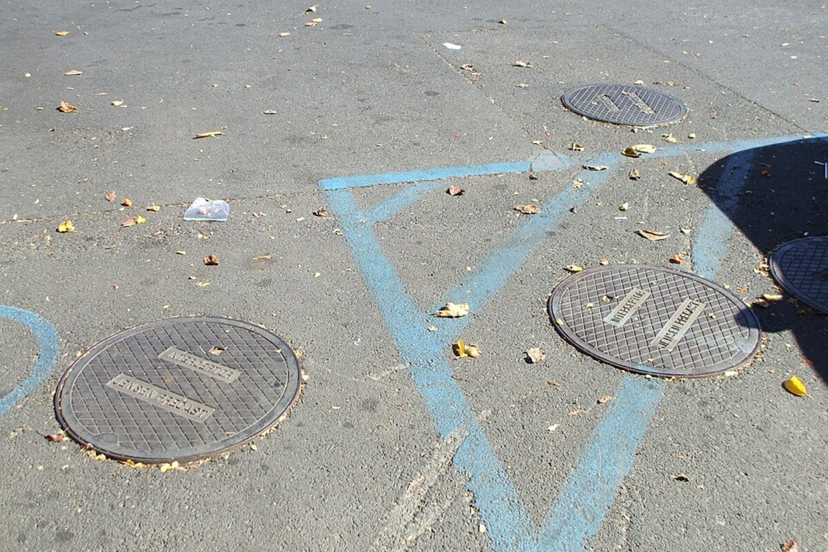 In-ground grease trap access covers in a commercial parking lot