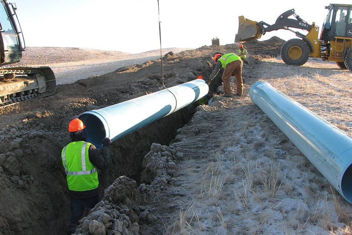 Construction crew working on an underground utility installation site
